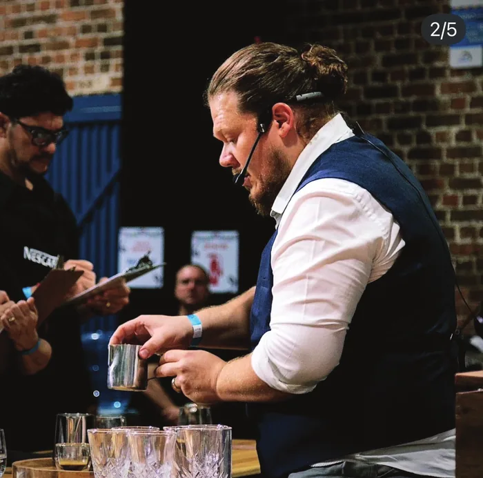 Ari Cyrman brewing coffee during a tasting