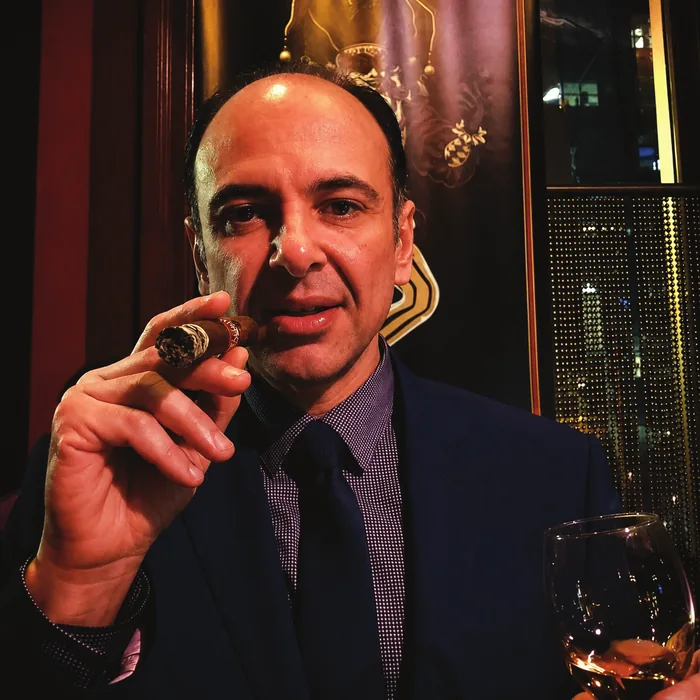Harry Mordjikian, founder of Harry's Habana Hut, holding a cigar